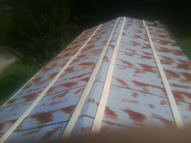 Rusted metal roof panels with new wood purlins before replacement — Storm Damage Roof Repair in White Bluff by Roofing Brothers